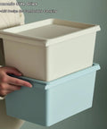 Person holding two stackable storage bins from the 8 Pack Stackable Storage Bins With Lids 5 Quart Plastic Toy And Craft Organizer Boxes Colorful Containers For Playroom Classroom And Office Supplies Organization Kid Friendly Space Saver set.