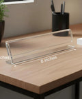 Clear Acrylic Desk Name Plates 12 Pack With Horizontal Slant Back 2x8 Sign Holders on wooden desk, tent style display.