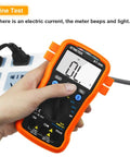 Hand using BT-39K Digital Multimeter With Case Pro Grade 4000 Count Volt Ohm Amp Tester on power strip