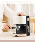 Quiet Compact Electric Coffee Machine Automatic Espresso Maker With Milk Frother, user operating espresso portafilter.