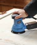 Beefy 4.9 Inch Random Orbital Sander Corded Power Tool With Full 20 Piece Sandpaper Roll Kit in use on a wood surface.