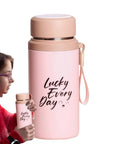Woman holding pink 800ml insulated water bottle with tea infuser, vacuum-sealed leakproof stainless steel flask for gym, travel, hiking.