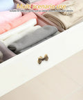 Copper Bowknot Cabinet Handle And Drawer Pull Kit In Vintage Brass Finish, installed on a white drawer front in a wardrobe setting.