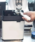 Premium Slick Silver Electric Espresso Portafilter Cleaner Paired With Solid Knock Box, showing portafilter in use.