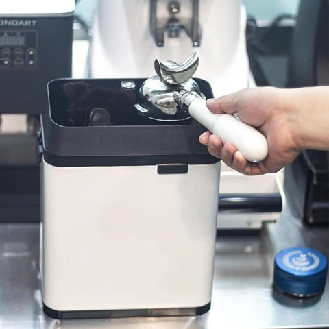 Premium Slick Silver Electric Espresso Portafilter Cleaner Paired With Solid Knock Box, showing portafilter in use.