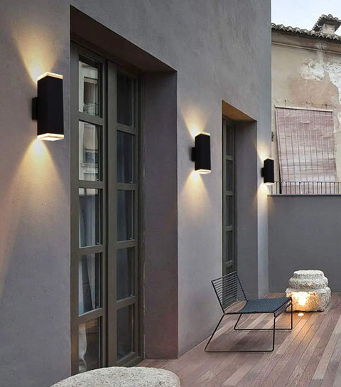 13 Inch LED Modern Square Aluminum Outdoor Wall Light with Matte Black Finish 20W 3000K Warm White Up and Down Sconce shown on patio wall