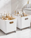 White storage bins on wheels filled with beauty products, ideal for organized bathroom use.