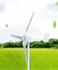 Front view of a white wind turbine with three nylon blades on a tall pole in a green field
