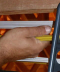 Hands using Box Of Fifty H2 Homer Helpers For Electrical Wire Management to organize yellow cables in a rugged bracket.