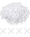 Pile of white plastic cross-shaped tile spacers, 1/16 in, 500 pcs for ceramic tile installation