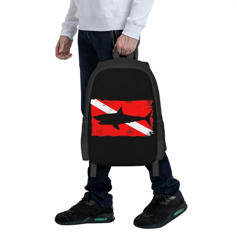 Person holding Vintage Shark Scuba Dive Flag Backpack For Unisex, featuring red and white dive flag print on polyester.