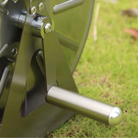 Close-up of heavy duty stainless steel garden hose reel crank handle for smooth rollup, on grassy surface.