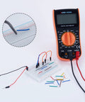 840 Pcs Breadboard Jumper Wires Kit With 14 Lengths Pre Stripped And Pre Formed Right Angles Solderless Flexible Cables shown with multimeter.