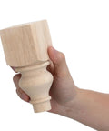 Person holding two round wood loveseat legs unfinished sofa feet with carved surface and hardware for kitchen table or bench