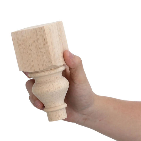 Hand holding Two Pack 5.9 Inch Solid Wood Sofa Feet With Carved Round Base Unfinished Wooden Farmhouse Legs For Couch Coffee Table Or Bench Easy Install Sturdy Replacement For Dated Or Wobbly Furniture.