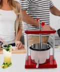 1.6 Gallon No Sweat Manual Press For Fruit Wine And Cheese Real Deal Food Grade Stainless Steel Body with red handle and base.