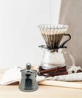 Turkish Style Stainless Steel Coffee Pot And Milk Pot With Lid Wooden Handle Spout Stovetop Butter Melting Pot 250Ml on counter