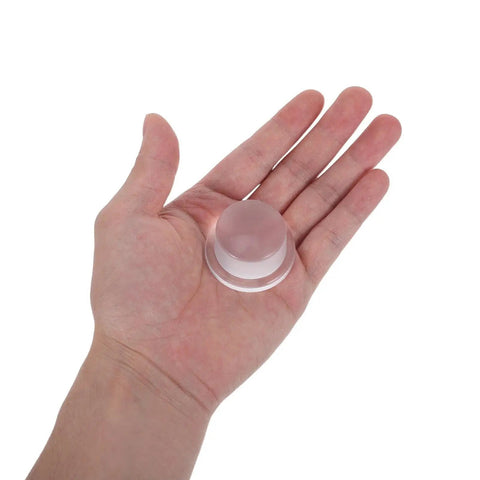 Hand holding clear 3 Pack Silicone Door Stoppers For Wall Protection With Adhesive Cylindrical Knob Shields Quiet And Durable Door Bumpers