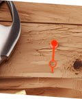 Close-up of a red plastic cap from 200Pcs Butter Mouth Cap Grease Extension Fitting Caps And Nozzles Kit on wooden surface.