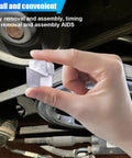 Hand holding 2 Piece Metal Stretch Belt Mate Kit Auxiliary Pulley Belt Installer Tool in front of engine pulleys