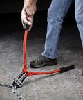 Using 24-Inch High Leverage Compound Bolt Cutter With Stabilizer Handles, Center-Cut Jaws on metal chain, demonstrating cutting power.