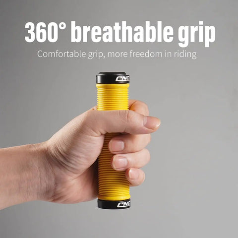 Hand holding Yellow MTB Grips For Mountain Bikes And BMX With Double Aluminum Lock Ring Grippy TPR Rubber Sweat Absorbing