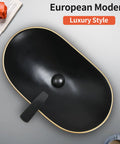 Overhead view of Large Matte Black Oval Vessel Sink With Gold Trim And Pop Up Drain For Above Counter Bathroom Use