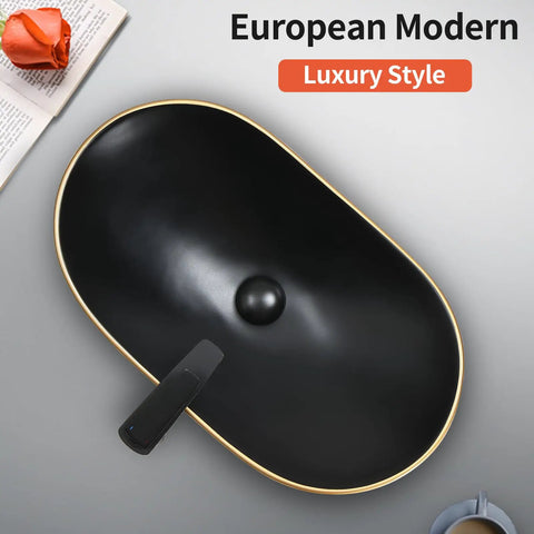 Overhead view of Large Matte Black Oval Vessel Sink With Gold Trim And Pop Up Drain For Above Counter Bathroom Use