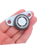 Set Of Four Adjustable Door Wheel Rollers For Sliding Closet Barn Doors With Heavy Duty Silent Pulleys on a hand showing close-up detail.