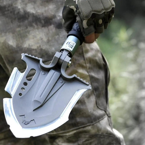 Hand holding Survival Shovel Multitool 28 In 1 For Camping And Hiking, Tactical Folding Shovel With Unbreakable Martensitic Steel