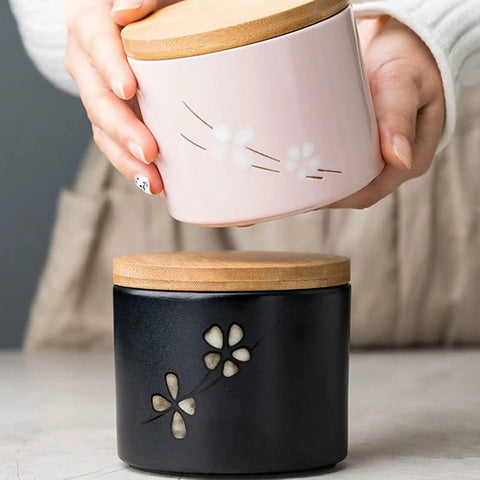 Matte Black Ceramic Coffee Canister With Premium Airtight Seal Keeps Your Daily Grind Fresh No Fuss Wide Mouth Design For Easy Scooping And Reliable Kitchen Pantry Storage with decorative flower design.
