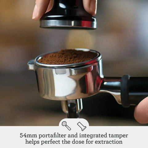 54mm portafilter and integrated tamper preparing coffee grounds for extraction in Pro Level Espresso Machine With A Rock Solid Steam Wand For Silky Microfoam And Volumetric Shot Control In Heavy Duty Brushed Stainless Steel Frame Built For Pulling Seriously Smooth Cafe Style Lattes Right At Home Any Day.
