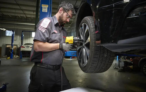 Technician using Precision Crafted Half Inch Drive Pneumatic Impact Wrench Producing Six Hundred Twenty Five Foot Pounds Of Torque At Ten Thousand Rpm.