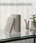 Clear Acrylic L Shaped Bookends For Desk And Shelf Organization on a glass desk with books and plant, minimalist design