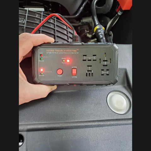 12V Automotive Relay Tester Kit With Battery And Alternator Check, Tests 4 And 5 Pin Relays held by a hand during car inspection