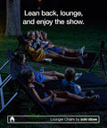People lounging on adjustable chaise lounge with 2 inch foam pad and portable carry case during outdoor movie night.