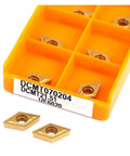 Rock Hard 10 Piece DCMT070204 Carbide Turning Inserts displayed in an orange holder with two inserts outside.