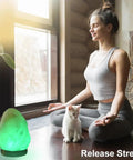 Woman meditating with cat beside Himalayan Salt Lamp With 8 Color Changing Glow For A Cozy Lit Vibe 100 Percent Natural Crystal Salt Light