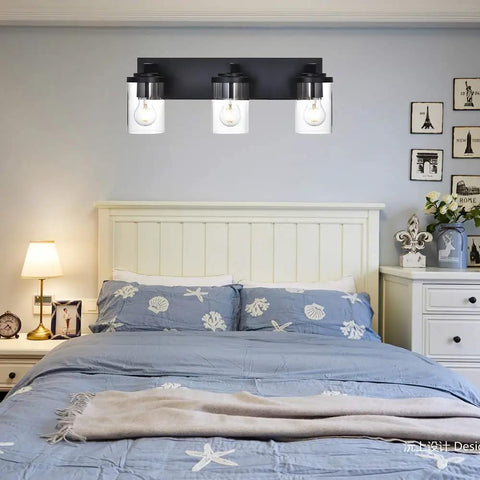 Modern 3 Light Vanity Light Fixture in Black With Clear Glass Shades for Bathroom Wall above bed in bedroom setting