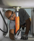 Person using the 12 In 1 Faucet And Plumbing Multi Tool For Sink Toilet And Faucet Installations And Repairs with Tab Mount Wrench under sink