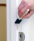 Heavy Duty Paint Roller Kit With Precision Trim Brush For Tough Corners And Crisp Lines, person painting trim with precision brush.