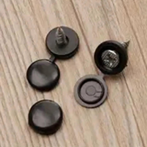 Fifty Pack Plastic Screw Cover Set Delivers Knockout Finish For Furniture And DIY Builds showing black plastic caps on a wooden surface.