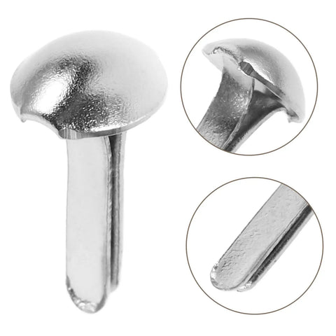 Close-up of silver iron brads from Shadow Puppet Craft Kit With 100 Iron Brads For Puppet Making, Paper Fasteners For Scrapbooking And Do It Yourself Decor.