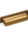 Close-up of a brass cup pull from the 10 Pack 2.5 Inch Antique Brass Cabinet Handles And Cup Pulls Set For Kitchen Cabinets Vintage Drawer Pulls.
