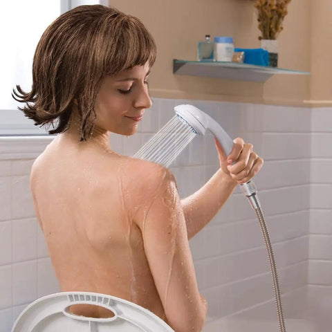 Person sitting using Detachable Handheld Shower Head With Hose For 3 Spray Settings Easy Turn Dial Gray Finish Keeps Bath Time Safe And Easy