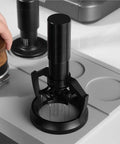 58mm Electric Espresso Stirrer And Wdt Tool With Fine Needles for smashing coffee clumps on a countertop.