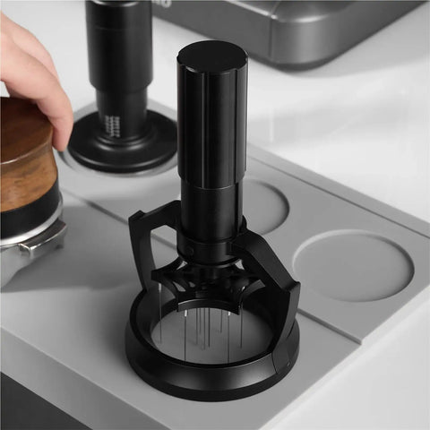 58mm Electric Espresso Stirrer And Wdt Tool With Fine Needles for smashing coffee clumps on a countertop.