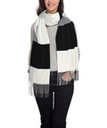 Black And White Piano Grid Winter Scarf Crafted From Plush Faux Cashmere With Extended Fringe Edges worn by woman.