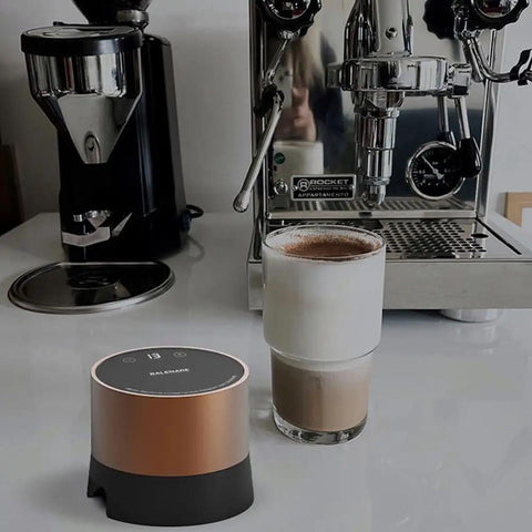 Smart Electric Coffee Tamper With 20 Level Adjustable Pressure And Precision Depth Control Featuring Steady Force For Flavor Packed Espresso Shots on counter with coffee cup.