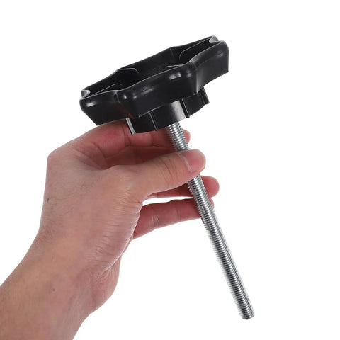Hand holding Spare Tire Hold-Down Bolt Replacement and Wheel Carrier Clamp Hardware for Vehicle Safety, black finish